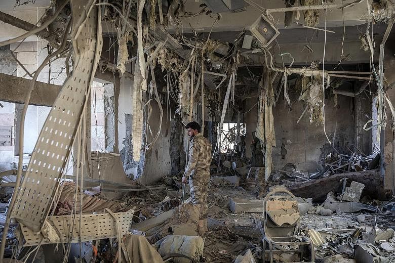 A destroyed hospital in Hajin, Syria, which was liberated from the Islamic State in Iraq and Syria last month. More than 37,000 people, mostly wives and children of hardline fighters, have fled ISIS territory since the Syrian Democratic Forces, backe