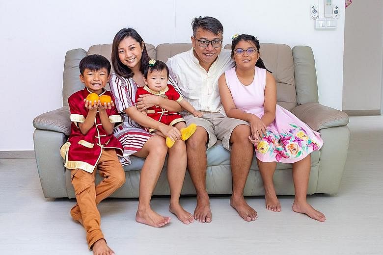 Ms Lim Zihui with her husband Royston Yap, 37, and their children - Nathan, eight; Nigel, eight months old; and Noelyn, 11 - in their Punggol executive apartment, which is near her parents' home.