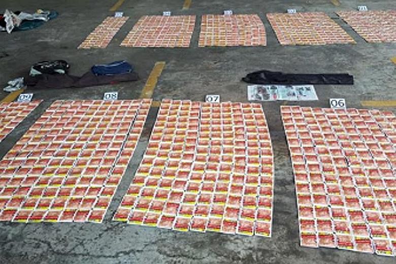 The packets of chewing tobacco (above) seized from the motorcyclist at the Woodlands Checkpoint on Thursday. He had stashed them in his shoes as well as other places.