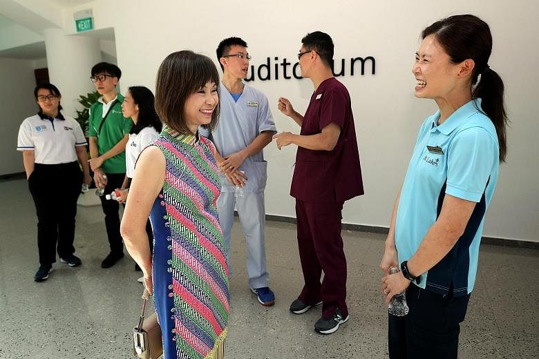 Senior Minister of State for Health Amy Khor speaking to Ms Angela Huang, who successfully made a mid-career switch to become a physiotherapist, at the launch of the new degree programme at Singapore Institute of Technology yesterday.
