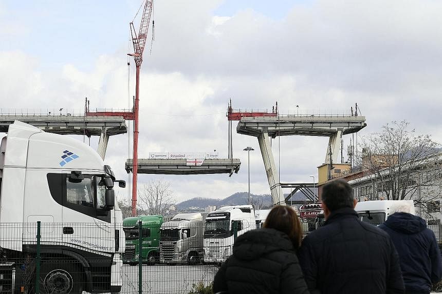 Demolition works at Morandi motorway bridge in the Italian port city of Genoa yesterday. Part of the bridge collapsed during a storm last August, killing 43 people.
