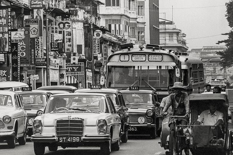 Traffic in North Bridge Road in 1968, when trishaws shared the road with cars and buses. Singapore's middle way helped show the world an alternative to communism and fascism in past decades, says the writer. The Republic can continue to show the worl
