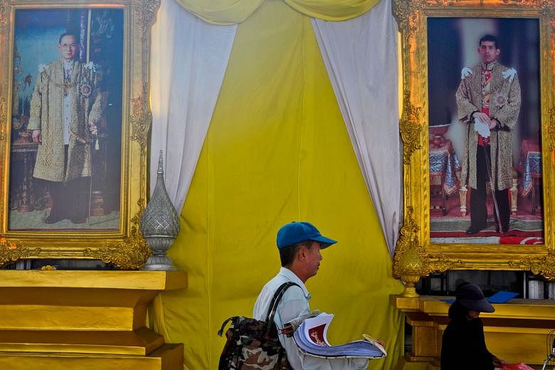 Portraits of the late Thai King Bhumibol Adulyadej (left) and current King Maha Vajiralongkorn near the Grand Palace in Bangkok. The Thai monarchy is, on paper, a constitutional monarchy that is officially above politics.