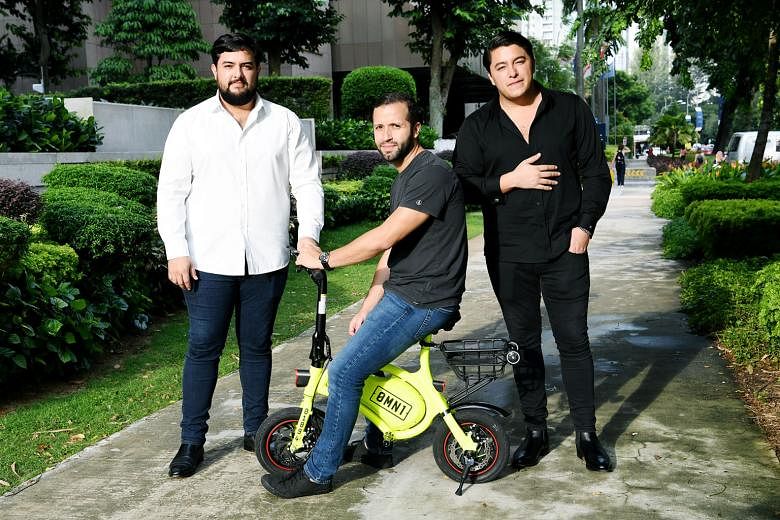Omni Sharing directors Oscar Moises Chaves (left) and his brother Samuel (right), with chief operating officer Carlos Abarca. Omni yesterday applied for a sandbox licence to rent out 500 e-scooters here under the 0mn1 brand.