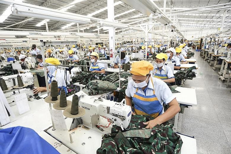Workers sewing military uniforms at the Sri Rejeki Isman factory in Central Java. The company has adopted automation and IoT to lower operational costs and enhance its competitive edge both locally and globally.