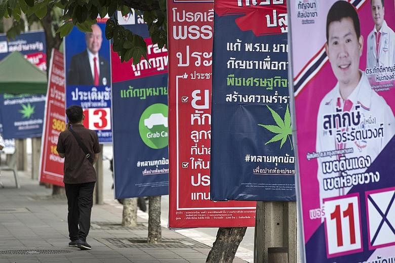 Posters of political parties lining a Bangkok street ahead of next month's election in Thailand.