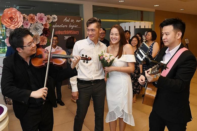 Love was in full bloom yesterday at the Registry of Marriages (ROM) as many couples chose to tie the knot on Valentine's Day, including (left) Mr Pang Sze Hou, 36, and Ms Wu Xuele, 28, and (below) Mr Suresh Naidu and Ms Suppiah Praba, both 35. ROM sa