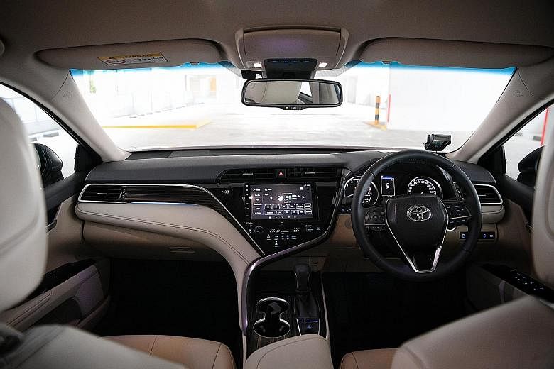 Slim lights, a prominent grooved grille and a soft wedge-shaped profile give the new Camry a more youthful look. Inside, the centre console is cradled in a chrome frame which folds like a kimono collar. In the boot, there is plenty of room for luggage.