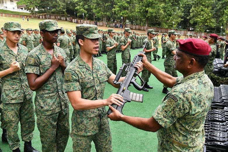 Above and right: Recruits of the Commando Training Institute were presented with their SAR-21 rifles in public for the first time yesterday, with the ceremony taking place at Fort Canning Green and witnessed by Communications and Information Minister