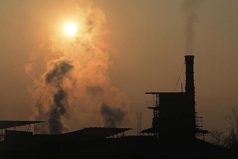 Smoke rising from a factory chimney in Amritsar, India. Actively engaging firms to adopt a sustainable and ethical business can promote more stable investment returns in the long run, says the writer.