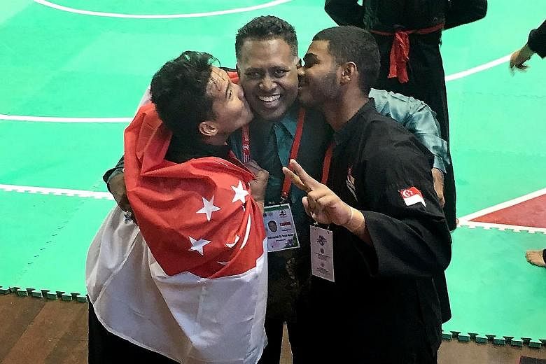 Singapore silat exponents Sheik Farhan (right) and Shakir Juanda kissing Singapore Silat Federation chief executive Sheik Alau'ddin after winning world titles in Bali in December 2016. Shakir, head of Persisi's athletes' commission that was formed la