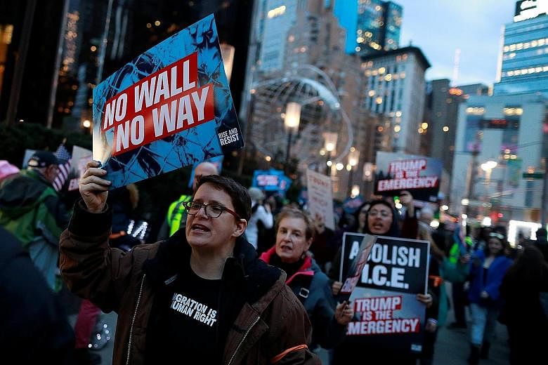 People gathering at Trump International Hotel & Tower in Manhattan on Friday to protest against US President Donald Trump's declaration of a national emergency to unlock funds for a border wall. Civil rights groups and Democrats have vowed to mount l