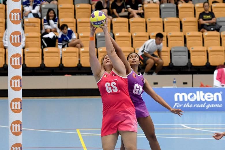 Sneakers Stingrays goalkeeper Reena Divya Manogaran challenging Blaze Dolphins goal shooter Lee Pei Shan for the ball in the opening match of the Netball Super League 2019 at Our Tampines Hub yesterday. The Stingrays won 46-45.