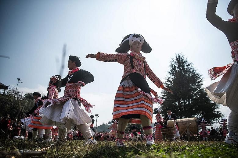 Girls from the Long Horn Miao, a branch of the Miao ethnic minority group, taking part in the annual flower festival or "Tiaohuajie" in the village of Longjia in China's Guizhou province to celebrate Chinese New Year. The dozens of dancers stood out 