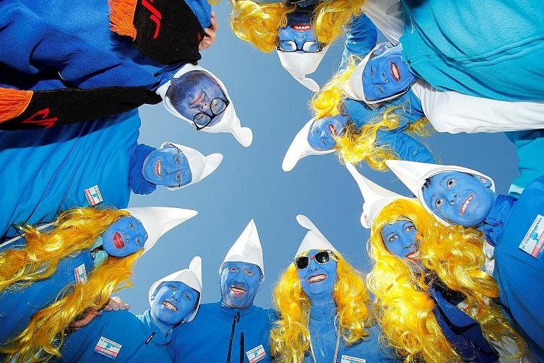 Participants dressed as smurfs posing in Lauchringen, Germany on Saturday, during an attempt to hold the world's largest meeting of smurfs in a bid to outdo a previous record. Fans of the blue elf-like creatures, created in a Belgian comic strip in t