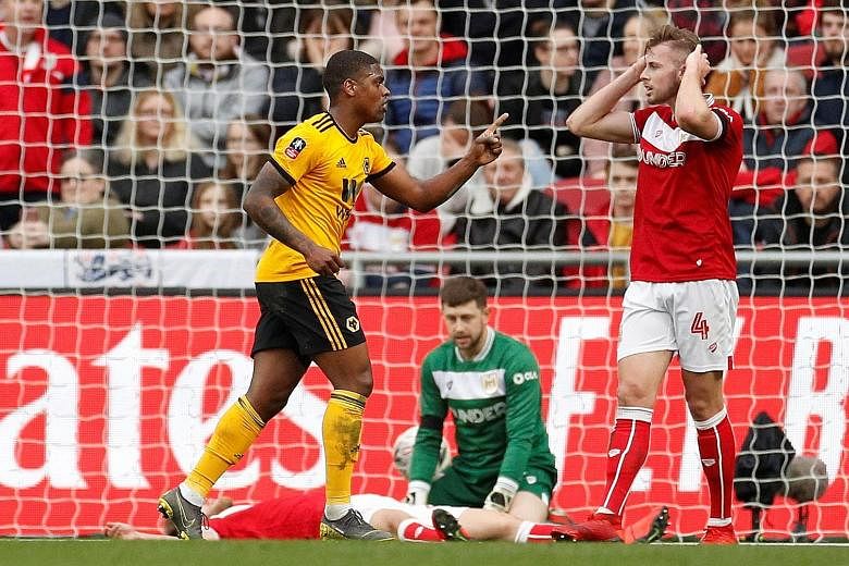 Wolves' Ivan Cavaleiro celebrates scoring their first goal yesterday as Bristol City's Adam Webster (No. 4) looks dejected at Ashton Gate, home of the Championship team. The Wolves forward's goal, after he slotted a cutback past Frank Fielding, turne