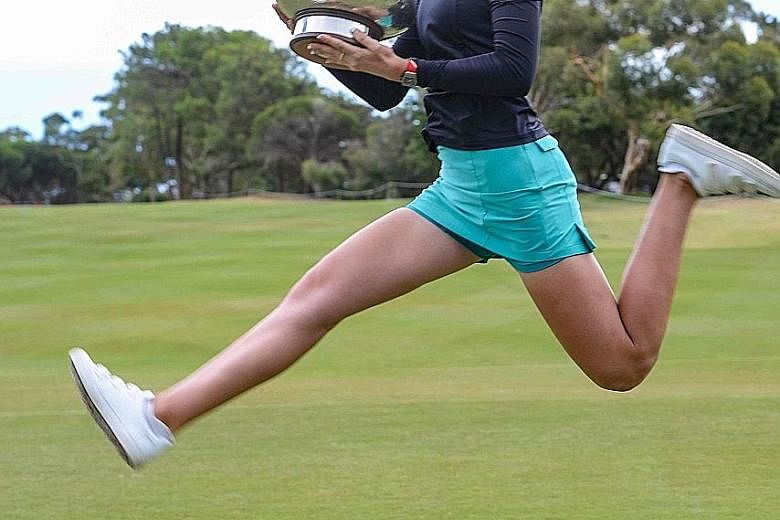 American golfer Nelly Korda celebrates winning the LPGA Australian Open in Adelaide yesterday with a trademark scissor kick - a family tradition first started by her father, Petr, when he won his first Grand Slam tennis title at the 1998 Australian O