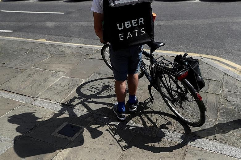 An Uber Eats cyclist in London last year. Uber chief financial officer Nelson Chai said that based on gross bookings, Uber Eats has apparently become the largest online food delivery business outside China.
