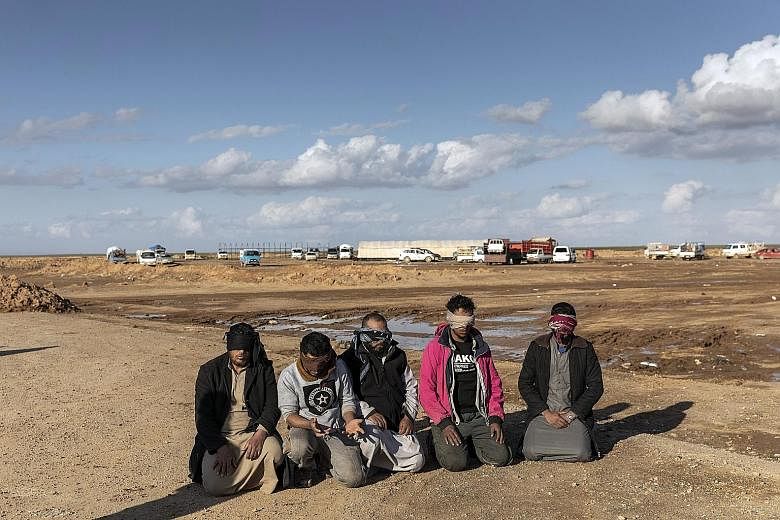 Suspected ISIS militants captured by the Syrian Democratic Forces (SDF) in Deir al-Zour province, Syria, last month. Once the US-led coalition declares it has taken all ISIS territories, the White House is expected to withdraw American troops. When t