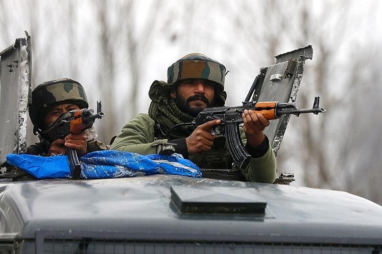 Indian army soldiers on patrol yesterday near the site of last Thursday's bomb attack in Pulwama, Kashmir. The suicide attack has sparked outrage in India with calls for revenge circulating on social media and rising animosity towards Kashmiri Muslim