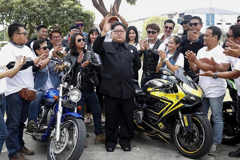 Mr Uthen Luangsangthong, a Thai impersonator of North Korean leader Kim Jong Un, winning applause during a donation drive at an orphanage in Samut Prakan province on Sunday. The billionaire businessman found out about his resemblance to Mr Kim five y