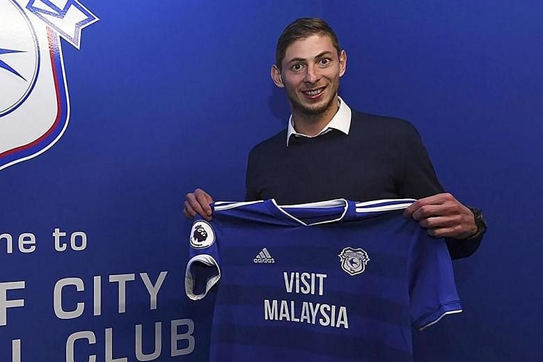Emiliano Sala with Cardiff's jersey on Jan 20 after signing for the Premier League side. His plane crashed over the English Channel the next day. The Argentinian was buried in his home town Progreso on Saturday.