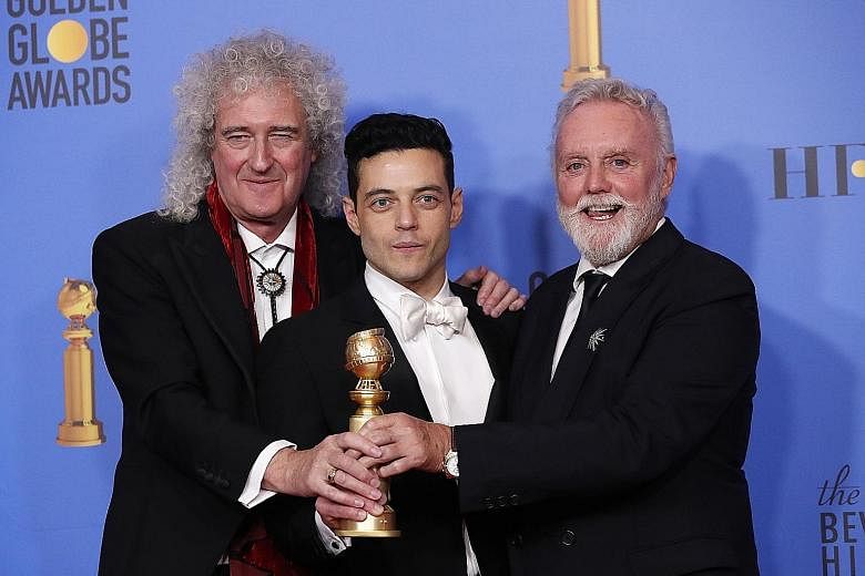 Queen's Brian May (far left) and Roger Taylor (left), seen here with Bohemian Rhapsody star Rami Malek in California last month, will perform at the Oscars ceremony on Sunday with former American Idol star Adam Lambert (above) on vocals.