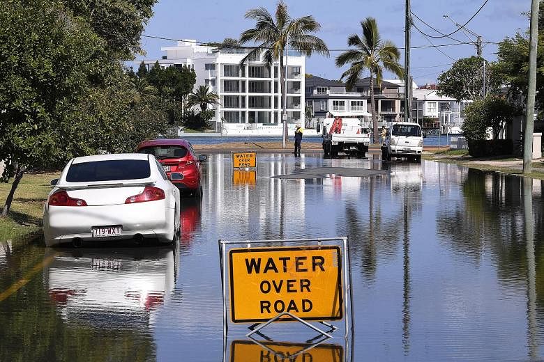 Flood waters covering a street on the Gold Coast in Queensland, Australia, yesterday as the brunt of Cyclone Oma approaches in the coming days.