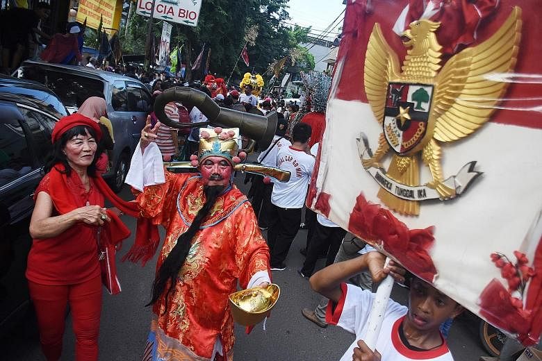 A performer dressed as the Chinese God of Fortune at a Chap Goh Meh carnival in Jakarta on Tuesday. Many such celebrations were held across Indonesia to mark the 15th and last day of Chinese New Year. Before President Suharto's fall in 1998, the Chin