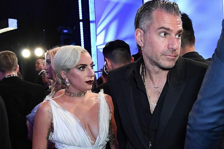 Singer Lady Gaga and talent agent Christian Carino (both left) had shown up together at the Screen Actors Guild award ceremony earlier this year.