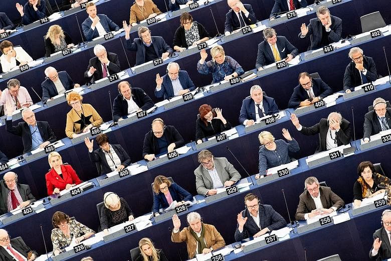 European legislators voting for the upcoming European Union-Singapore Free Trade Agreement at the European Parliament in Strasbourg, France on Feb 13. The EU-Singapore Investment Protection Agreement and a partnership and cooperation agreement were a