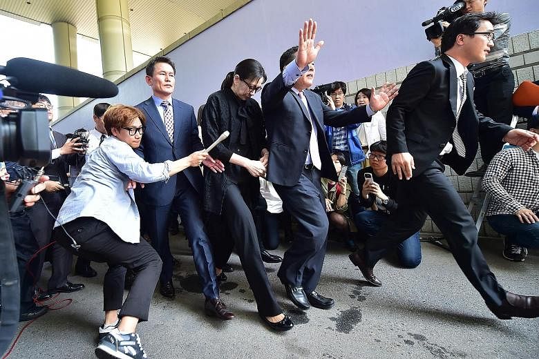 Korean Air executive Cho Hyun-Ah (centre) after she received a suspended jail sentence from a court in Seoul, in May 2015, over her "nut rage" tantrum on board a plane the year before. Cho's husband has accused her of abusing him and their young chil