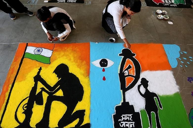 Students taking part in an inter-college Rangoli competition at the Sardar Vallabh Bhai Patel Polytechnic College in Bhopal, India, on Thursday. The college paid tribute to the soldiers who were killed in a militant attack in Kashmir's Pulwama distri