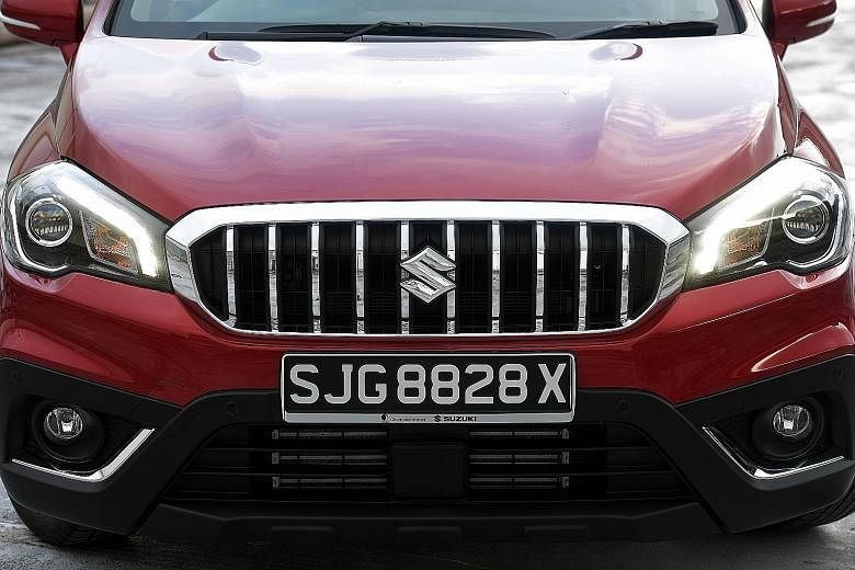 The Suzuki S-Cross has a prominent chrome-lined feature with vertical slats that looks like a merged version of BMW's iconic double-kidney grille.