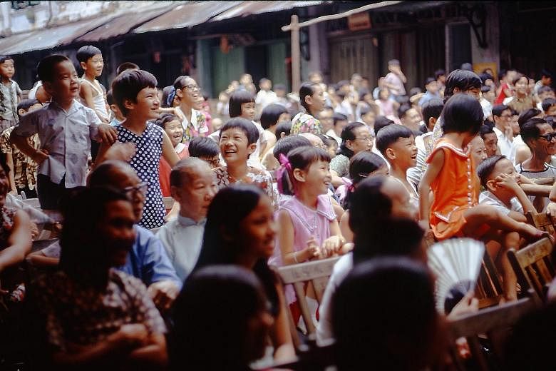 Children outside a shuttered shop in Gemmill Lane, in the Telok Ayer area, 1977. The many local scenes captured by Mr Paul Piollet (right) include (far right) that of people young and old being enraptured by an opera performance in Chin Nam Street, 1
