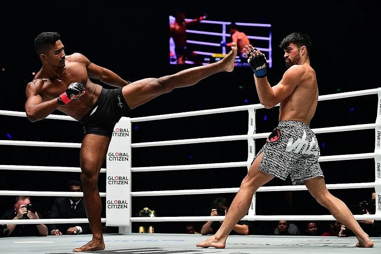 Singaporean Amir Khan aiming a kick at Costa Rican Ariel Sexton in One's lightweight Grand Prix quarter-finals last night. Sexton won the match by submission.