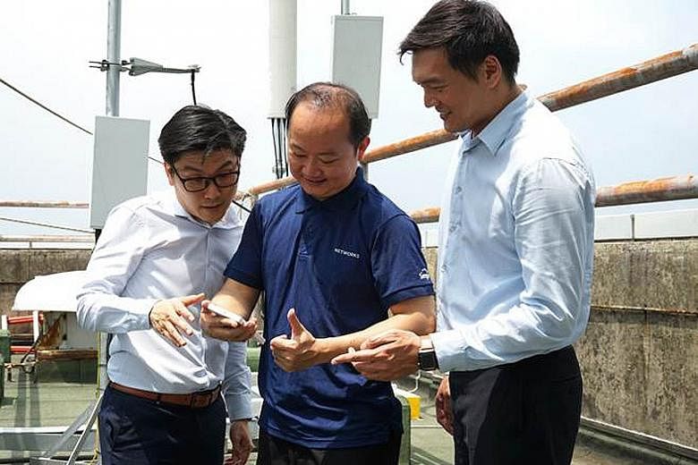 Singtel engineers in Singapore using the Oppo 5G test device during the three-minute 5G video call with their Optus counterparts in Sydney.