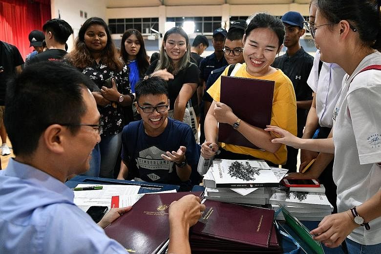 Students receiving their A-level results at Jurong Pioneer Junior College yesterday. Both Jurong JC and Pioneer JC - which merged into Jurong Pioneer JC - achieved better performances than in the previous year.