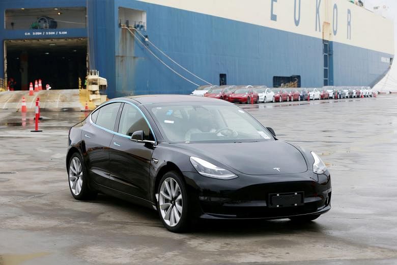 A Tesla Model 3 car leaving a cargo vessel at a port in Shanghai yesterday. The California-based firm has already adjusted prices and added a cheaper Model 3 variant to its line-up to make its US-made cars more affordable in China amid high import ta