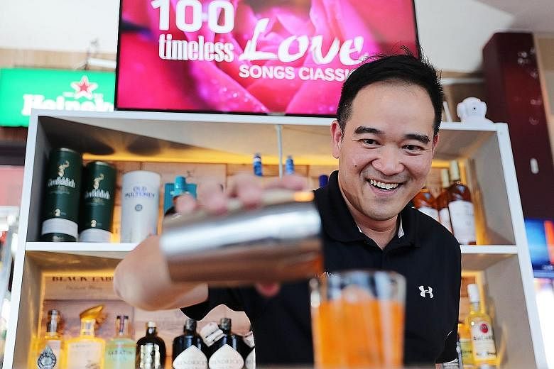 Mr Sam Weng Cham reliving a bartending moment at Happy Hut in Kallang Avenue for the photographer. The decision to enrol in an IT course 17 years ago changed his life, he says. Five years ago, he became a technopreneur and co-founded Transcend Soluti