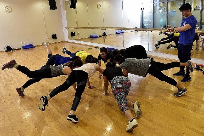 Top: Fitness instructor Derrick Chew conducting a functional fitness class at OCBC Arena. Above: This class is among a range of fitness classes offered by Sports Hub this quarter.