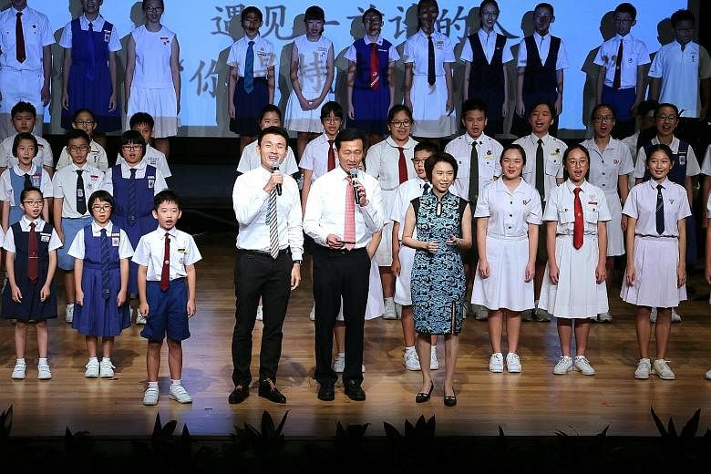 Mr Ong Ye Kung (centre) reciting a Chinese poem with Mr Baey Yam Keng and Ms Low Yen Ling at the launch of a book commemorating the 40th anniversary of SAP schools yesterday.