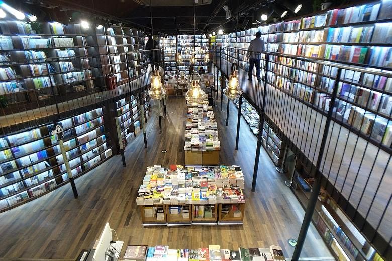 Sanlian Taofen, a 24-hour bookstore that opened in Beijing's Sanlitun neighbourhood last April, draws a steady late-night crowd through the week. Its attractions include an unusual layout of elevated walkways and two-storey bookshelves, as well as a 