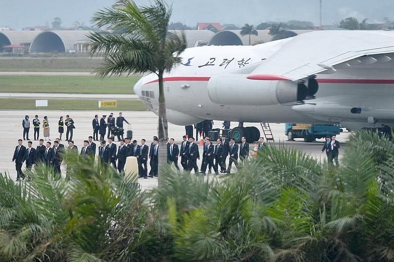 Above: Some 100 bodyguards for North Korean leader Kim Jong Un arriving yesterday at Noi Bai International Airport in Hanoi, Vietnam, on a North Korean cargo plane ahead of the summit. Right: Mr Kim Jong Un (centre) being sent off by his top official