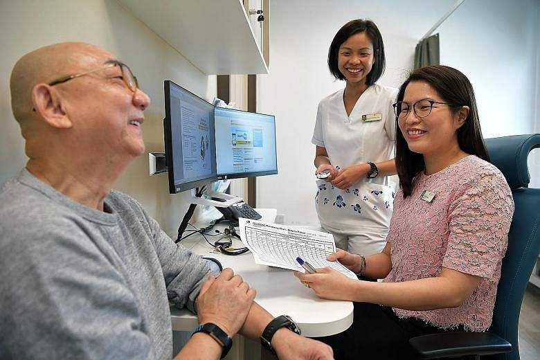 Mr George Then has seen his blood sugar level drop to a healthy level under the teamlet care programme with Dr Tricia Chang (seated) and care manager Evonne Oh.