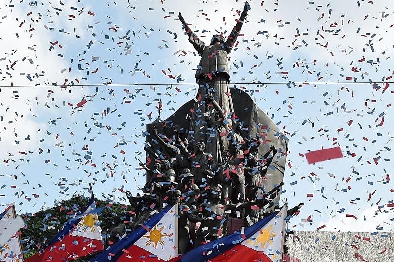 Confetti being showered on the People Power monument to commemorate the 33rd anniversary of the revolt yesterday.