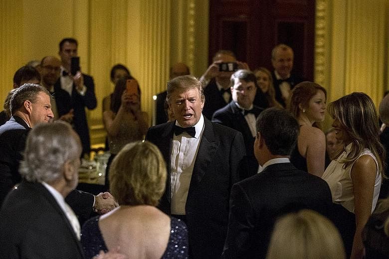 United States President Donald Trump (centre) and First Lady Melania Trump (far right) at the Governors' Ball in the White House on Sunday. Mr Trump had announced that the tariff hike on US$200 billion (S$270 billion) worth of Chinese goods, schedule