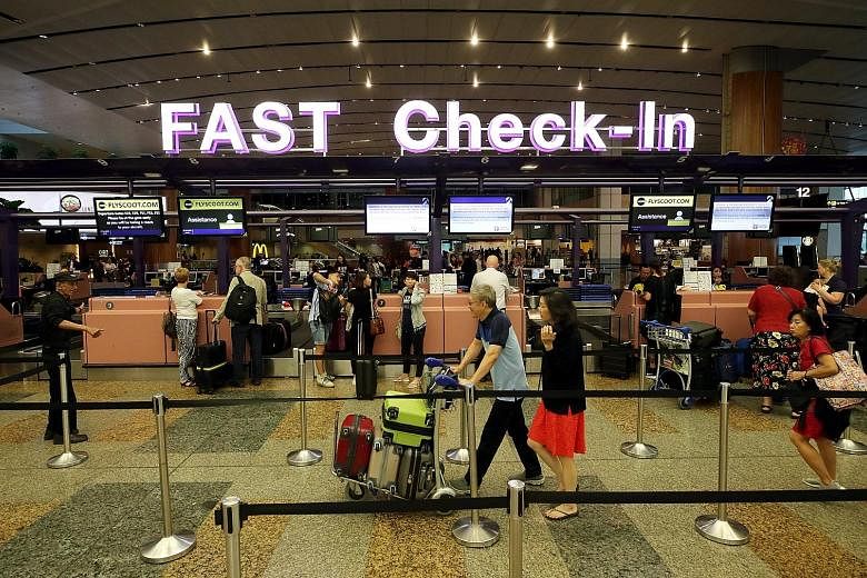Passengers at Changi Airport's check-in counters. The Department of Statistics said revenue growth for business services - which include real estate, travel, security and professional services - cooled to 1.3 per cent in the fourth quarter of last ye