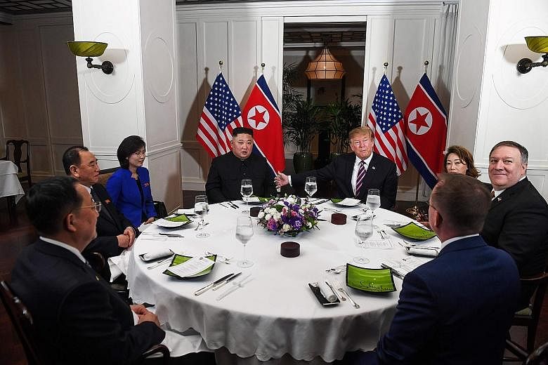 North Korean leader Kim Jong Un and US President Donald Trump at their dinner meeting at the Sofitel Legend Metropole Hanoi yesterday. With them are (clockwise from far left) North Korean Foreign Minister Ri Yong Ho; Mr Kim Yong Chol, vice-chairman o