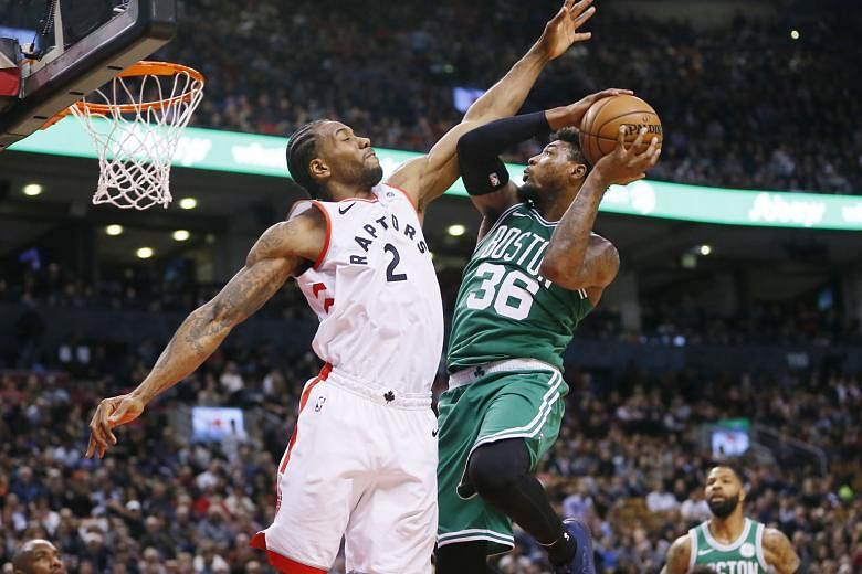 Toronto Raptors forward Kawhi Leonard trying to block a shot by Boston Celtics guard Marcus Smart at the Scotiabank Arena on Tuesday night. The Raptors won the National Basketball Association game 118-95 to record their eight straight home victory ov